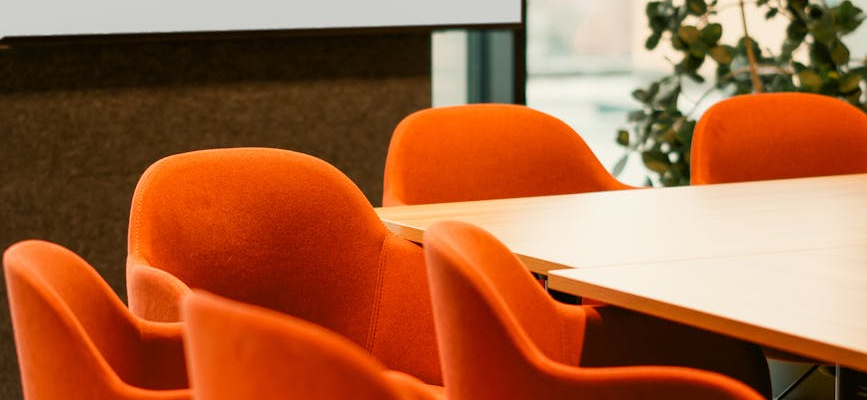 modern office conference room with orange chairs